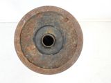 a rusted metal object on a white surface