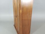 a small wooden cabinet with a door on top of it