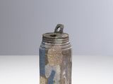an image of a small jar with a lid on a table