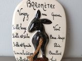a ceramic plaque with a picture of a donkey on it