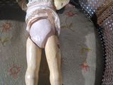 a doll that is laying down on a chair