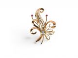 an image of a gold ring with pink stones on a white background