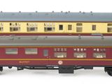 three model trains sitting side by side on a white surface