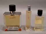 two bottles of perfume sitting next to each other on a white surface