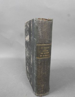 an old book sitting on top of a table next to a white background