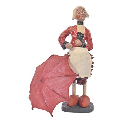 une figurine représentant une femme avec un parapluie rouge