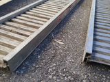 a picture of a train track laying on the ground next to a car