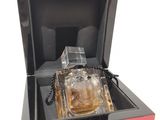 perfume bottle in a black box on a white surface
