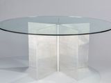une table en verre transparent avec un piètement en forme d'étoile et un plateau en verre transparent