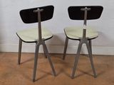 two chairs sitting next to each other on a wooden floor