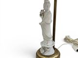 an image of a lamp with a statue on it and a cord plugged into it