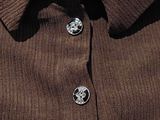 the shirt is brown and has two buttons on the collar