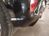 a close up of a car ' s front bumper and tire