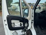 a white truck with its door open on the side of the road