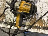 a corded drill on a table with a glove on it