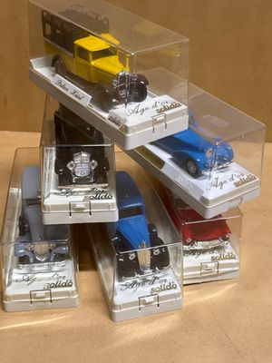 several toy cars are stacked on top of each other in a display case