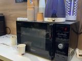 a microwave sitting on a counter in a coffee shop
