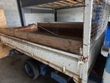 a white truck with a wooden bed in the back of it