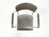 a metal chair with a wooden seat on a white floor