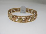 a close up of a bracelet on a table with a price tag
