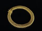 a gold bracelet on a black background