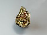 an image of a gold ring with a red and white diamond center