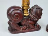 two figurines of a man and a dog on a table
