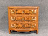 a wooden chest of drawers with drawers on top of it