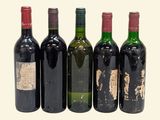 four bottles of red wine are lined up in a row