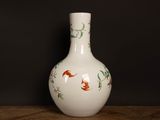 a white vase with a red fish design on it