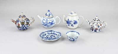 several pieces of blue and white porcelain teapots and bowls