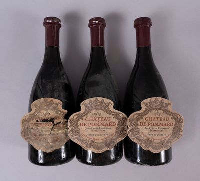 three bottles of wine with labels on them sitting next to each other