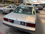 cars parked in a parking lot with a number plate on the back of the car
