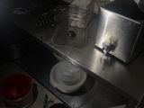 a small kitchen with a stove, sink, and a toaster