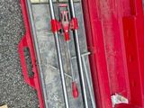 a red tool box with tools in it on the ground
