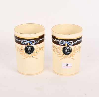 une paire de tasses de couleur crème ornées de motifs noirs et dorés