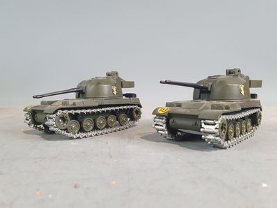 two toy tanks sitting side by side on a table