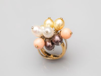 a gold ring with pearls and pearls
