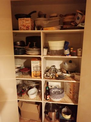 un garde-manger rempli de vaisselle et de plats sur les étagères