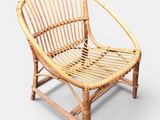 an image of a rattan chair with a wooden frame on a white background