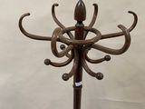 a metal coat stand with a coat rack attached to it
