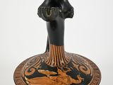 a black and orange vase with a bird on it