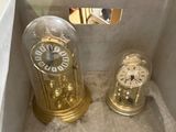 two clocks in a box with a mirror in the background