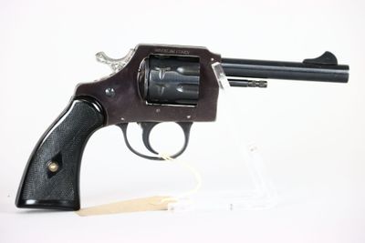gun on a white background with a wooden stick in the foreground