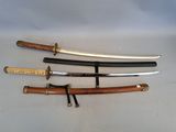 four different types of swords are displayed on a white surface