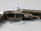 a close up of a gun on a table with a tag on it