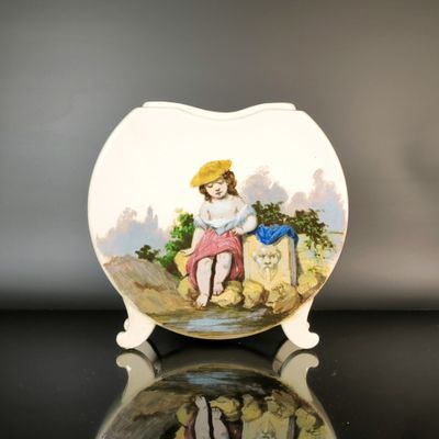a plate with a picture of a girl sitting on a rock
