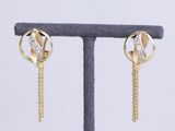 a close up of a pair of earrings on a stand