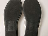 the soles of a pair of black shoes on a white surface