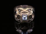 a close up of a ring with a diamond in it